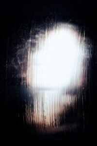Soft white light diffused through textured glass, creating a quiet, abstract glow.